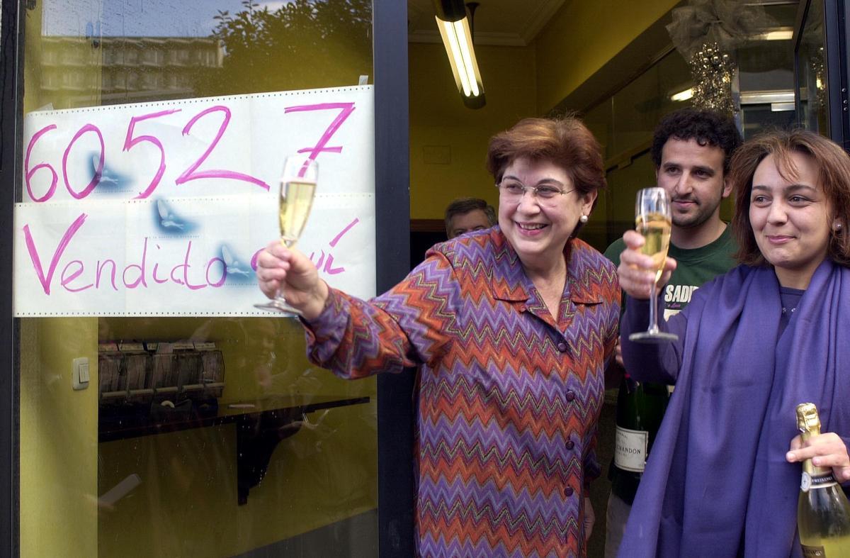 La lotera Dolores Lillo, ante la administración "El Gallo de Oro", que vendió el Gordo del sorteo del Niño en 2001.