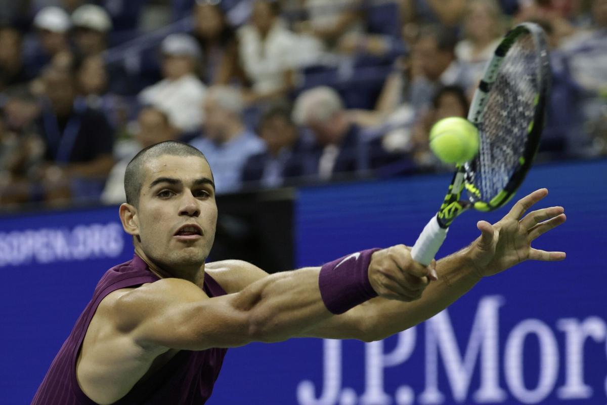 Carlos Alcaraz, of Spain, returns a shot to Reilly Opelka, of the United States, during the first round of the U.S. Open tennis championships, Monday, Aug. 25, 2025, in New York. (AP Photo/Adam Hunger)