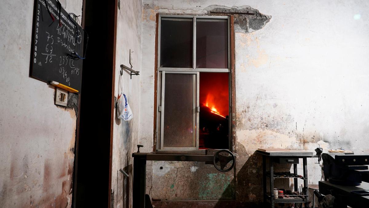 Lava is seen through a window in El Paso following the eruption of a volcano on the Canary Island of La Palma