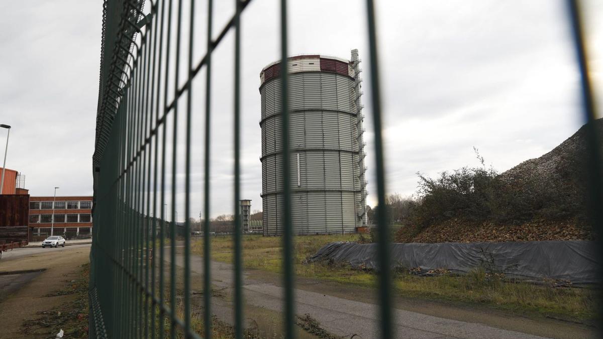 La valla que separa el PEPA de los antiguos terrenos de Baterías, con el gasómetro al fondo. | MARA VILLAMUZA