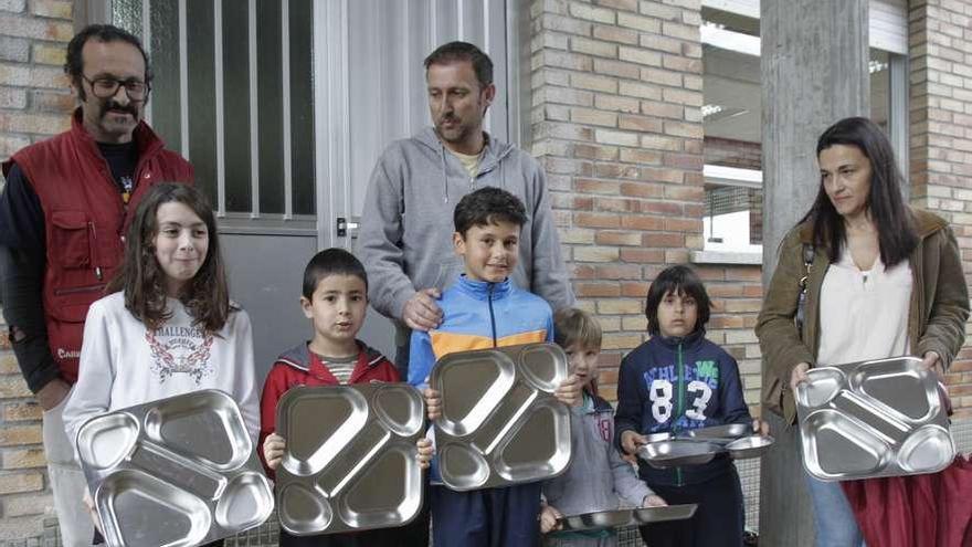 Padres y niños tuvieron que dejar las bandejas de acero fuera del comedor escolar.  // José Lores