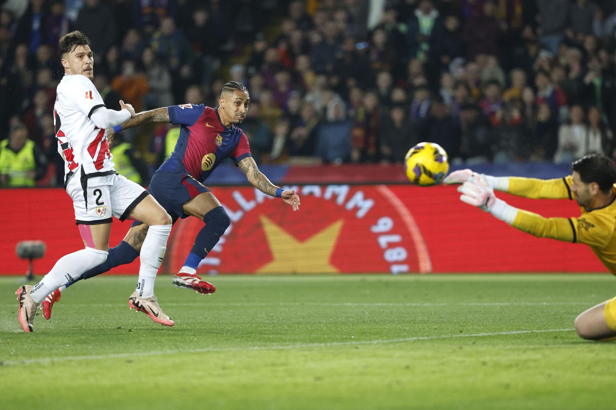 Barcelona's Raphinha, centre left, makes an attempt to score during a Spanish La Liga soccer match between Barcelona and Rayo Vallecano at the Lluis Companys Olympic Stadium in Barcelona, Spain, Monday, Feb. 17, 2025. (AP Photo/Joan Monfort). EDITORIAL USE ONLY/ONLY ITALY AND SPAIN