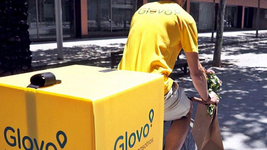 Un treballador de la plataforma Glovo portant una comanda.