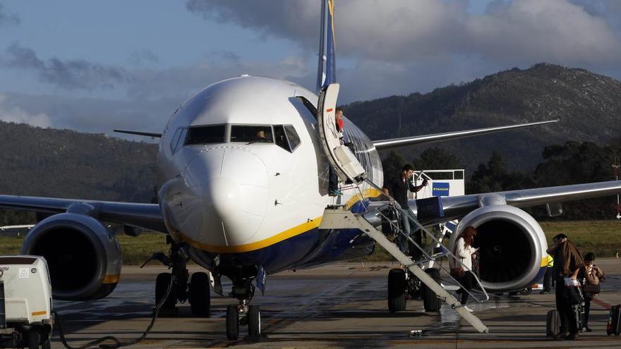 Pasajeros bajan de un avión de Ryanair en Peinador. // R. G