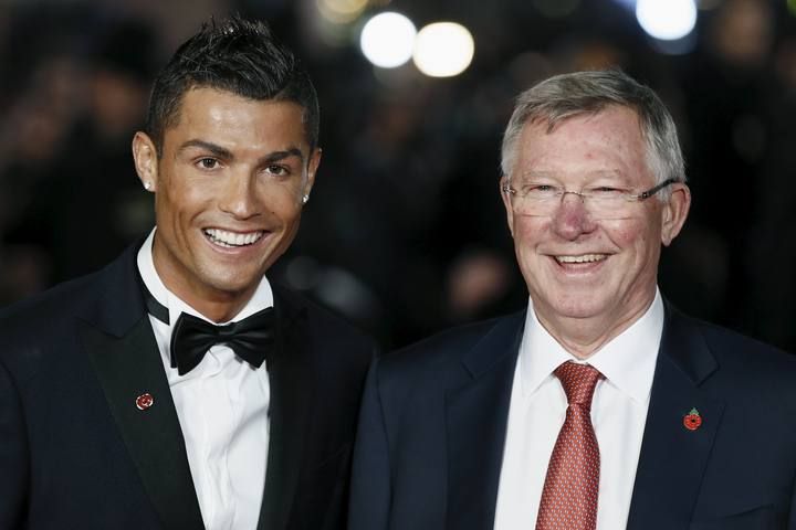 Soccer player Ronaldo and Ferguson pose for photographers on the red carpet at the world premiere of "Ronaldo" at Leicester Square in London