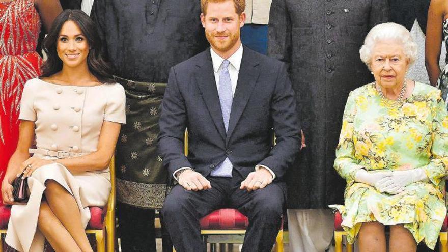 Meghan, Enrique y la Reina Isabel, en una recepción en el palacio de Buckingham, en 2018.