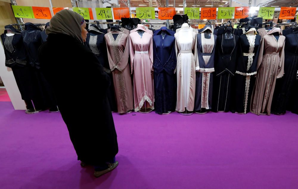 A visitor looks at women's clothes during the ...