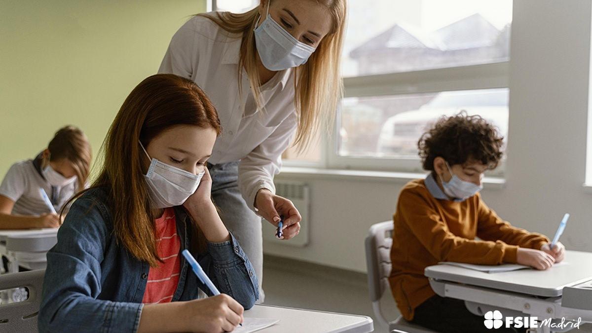 Alumnos en un aula con mascarilla.