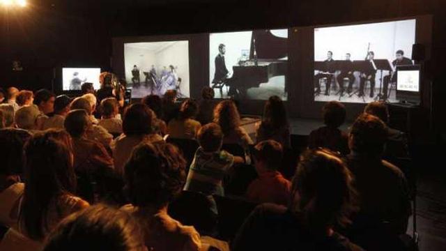 Espectadores, en el Marco, contemplando a los músicos a través de pantallas. // Ricardo Grobas