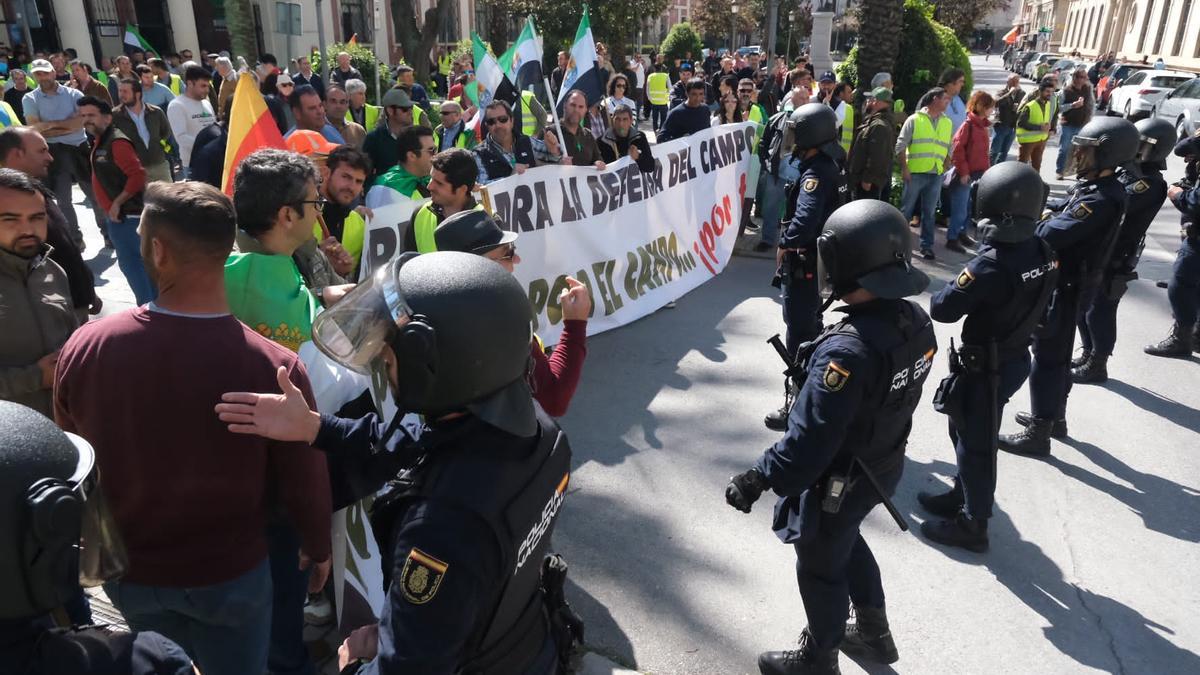 Agricultores y antidisturbios frente a la delegación del Gobierno.