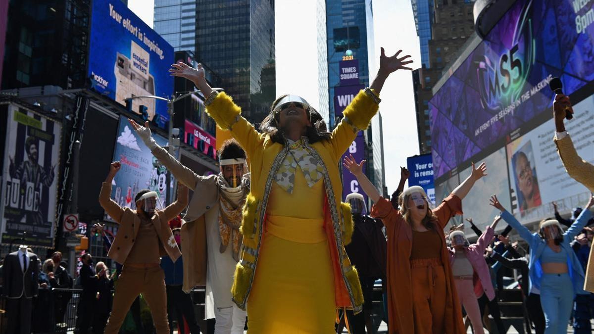 TOPSHOT - Performers participate in  We Will Be Back   a live pop-up event and commemoration of Broadway s  lost year  at Time Square on March 12  2021 in New York City  - The theater community reunited exactly one year since Broadway shutdown due to the covid-19 pandemic  (Photo by Angela Weiss   AFP)