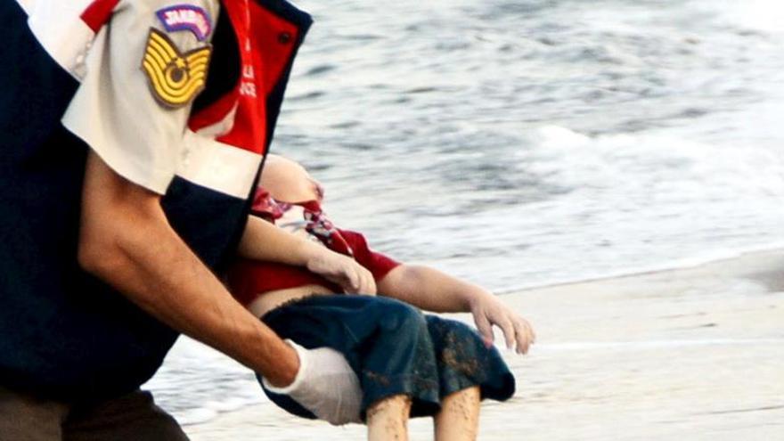 Un policía traslada el cuerpo sin vida del bebé Aylan.