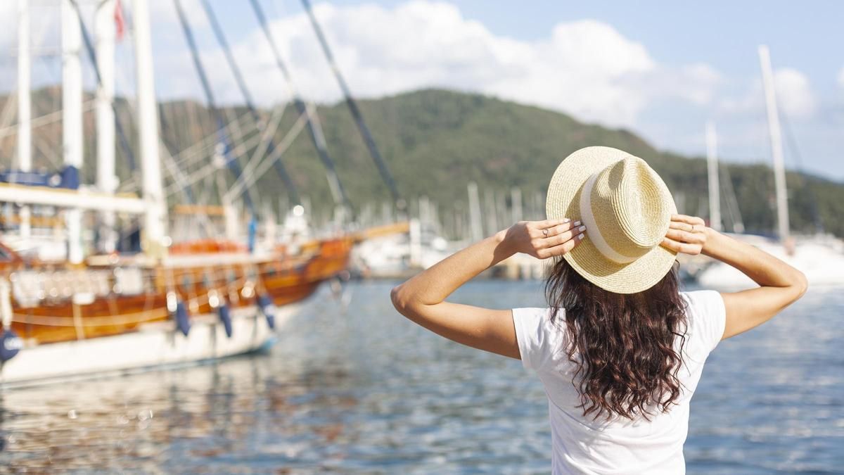 Una turista contempla les vistes d'un port