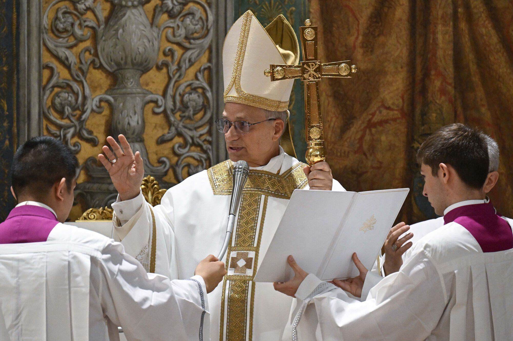 Newly elected Pope Leo XIV concelebrates Mass with the College of Cardinals inside the Sistine Chapel at the Vatican the day after his election as 267th pontiff of the Roman Catholic Church, Friday, May 9, 2025. (Vatican Media via AP). AP PROVIDES ACCESS TO THIS GOVERNMENT PRODUCED PHOTO SOLELY TO ILLUSTRATE NEWS REPORTING OR COMMENTARY ON FACTS DEPICTED IN IMAGE; MUST BE USED WITHIN 14 DAYS FROM TRANSMISSION; NO ARCHIVING; NO LICENSING; MANDATORY CREDIT