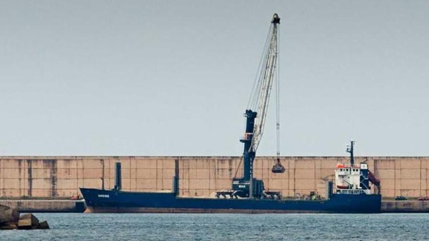 Una grúa, cargando las 7.000 toneladas de arcilla en el &quot;Brens&quot;, ayer, en la ampliación de El Musel.