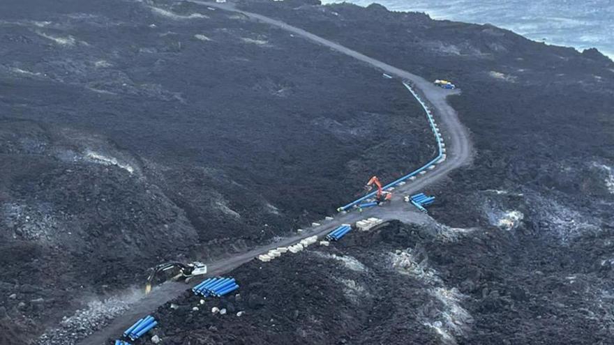 Un momento de la construcción de la tubería sobre la fajana generada por la erupción del volcán de Tajogaite. | | E.D.