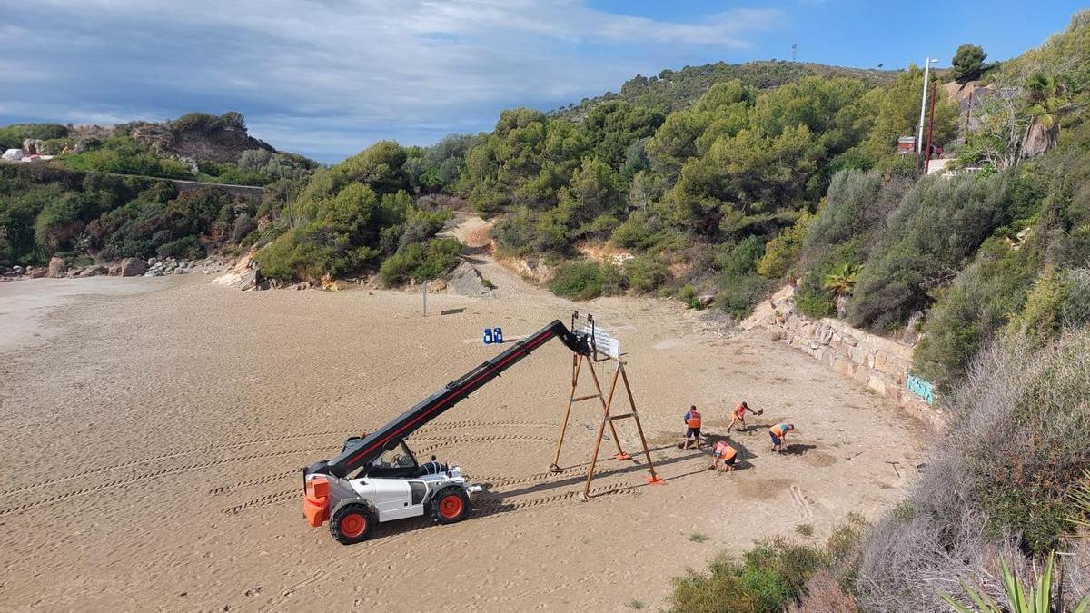 Foto de operarios montando el turístico columpio de playa de Orpesa.