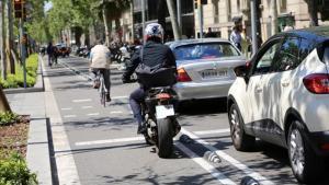 Una moto intenta alcanzar el semáforo por el carril bici. 