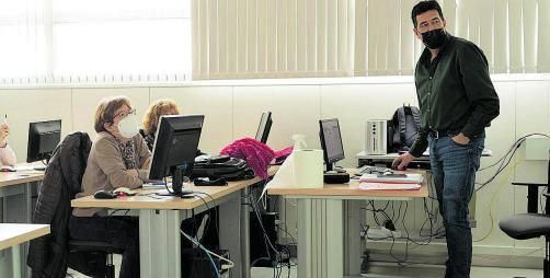 Dos alumnas en primera fila atienden al profesor.