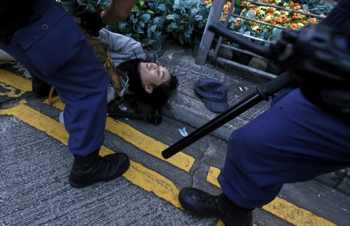 Riot police arrests a protester after a clash at Mongkok district in Hong Kong, China