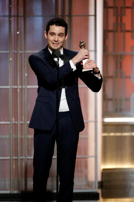 Director Damien Chazelle holds the award for ...