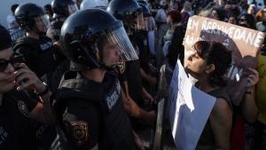 Una mujer con una pancarta se enfrenta a la policía antidisturbios que les bloquea, participa en una concentración para conmemorar el primer aniversario de la muerte de la mujer iraní Mahsa Amini, en Estambul, Turquía.