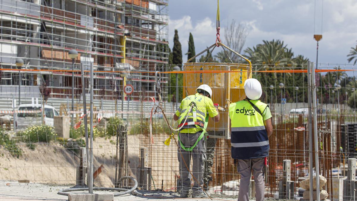 Varios obreros en la construcción de una promoción.