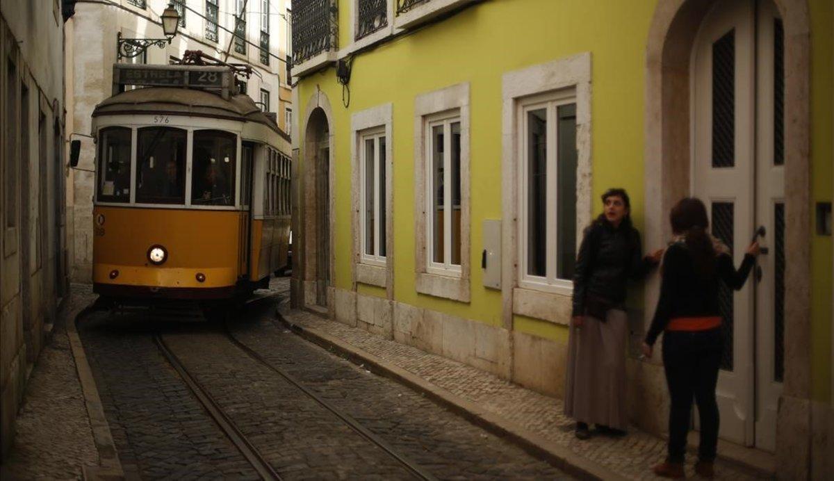 zentauroepp22073801 a tram travels through a street at alfama neighbourhood in l191023165048