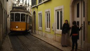 zentauroepp22073801 a tram travels through a street at alfama neighbourhood in l191023165048