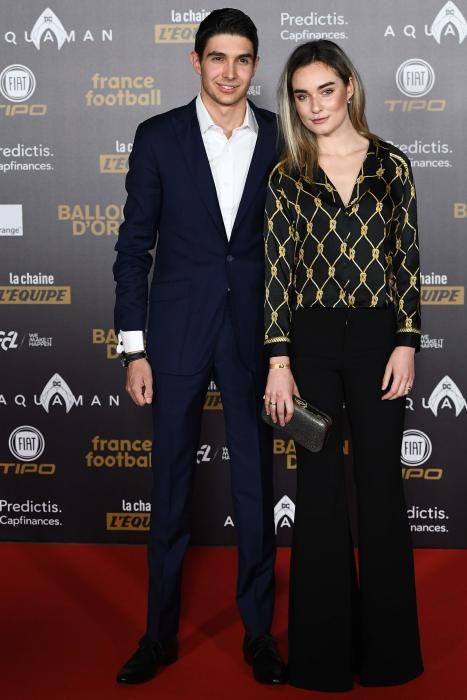 Formula 1's French driver Esteban Ocon (L) and guest pose upon arrival at the 2018 FIFA Ballon d'Or award ceremony at the Grand Palais in Paris on December 3, 2018. - The winner of the 2018 Ballon d'Or will be revealed at a glittering ceremony in Paris on December 3 evening, with Croatia's Luka Modric and a host of French World Cup winners all hoping to finally end the 10-year duopoly of Cristiano Ronaldo and Lionel Messi. (Photo by Anne-Christine POUJOULAT / AFP)