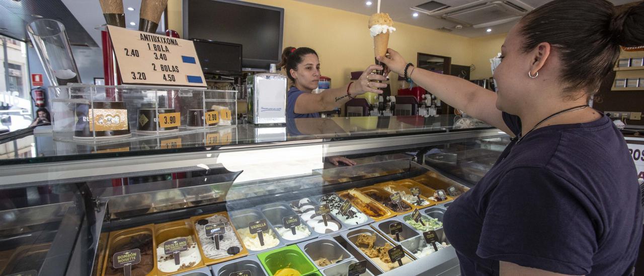 Una mujer compra un helado artesano en Alicante.