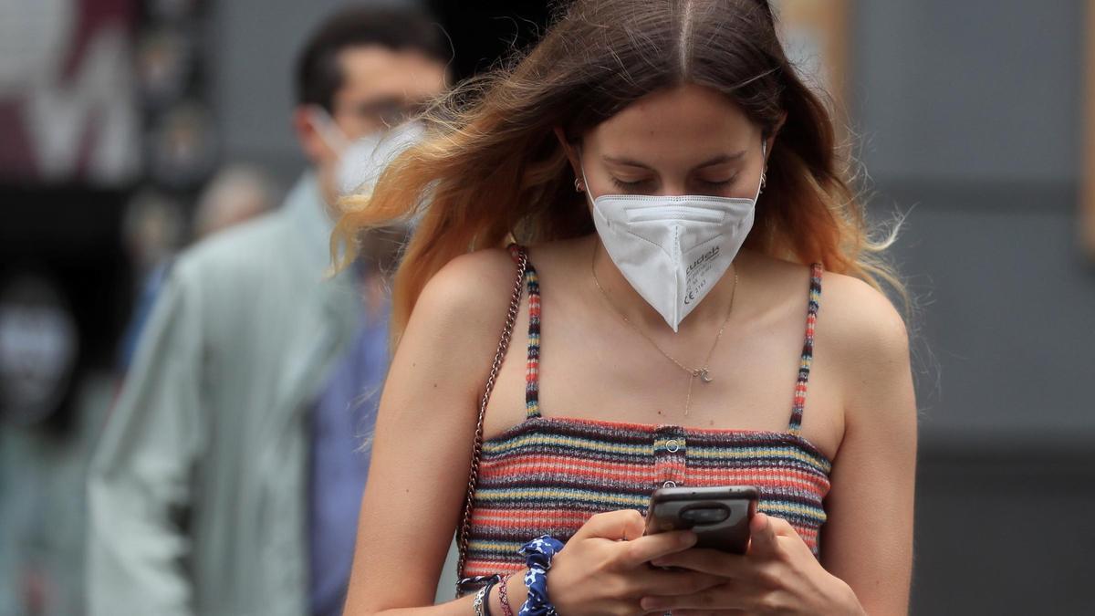 Una joven utiliza su teléfono móvil.