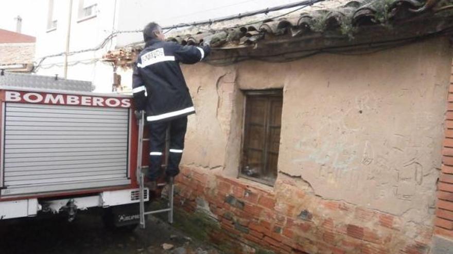 Los bomberos retiran las tejas de una vivienda por riesgo de desprendimiento