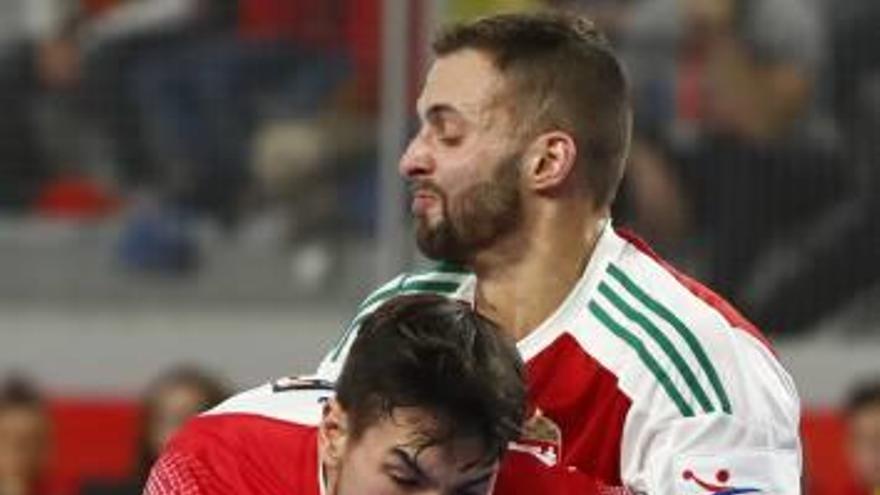 El español Dujshebaev, sujetado ayer por un rival húngaro.