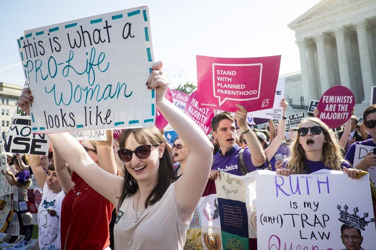 WASHINGTON, DC - JUNE 27: Pro-choice and pro-life activists demonstrate on the steps of the United States Supreme Court on June 27, 2016 in Washington, DC. In a 5-3 decision, the U.S. Supreme Court struck down one of the nation’s toughest restrictions on abortion, a Texas law that women’s groups said would have forced more than three-quarters of the state’s clinics to close.   Pete Marovich/Getty Images/AFP