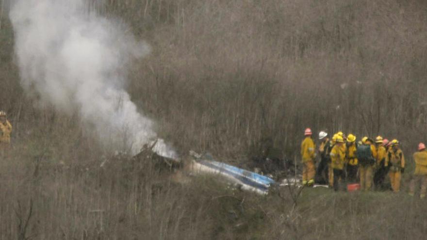 Bomberos junto al helicóptero de Bryant accidentado.