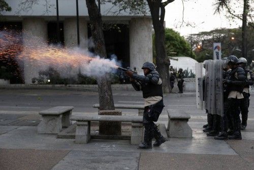 Police fire teargas at anti-government protesters at Altamira square in Caracas