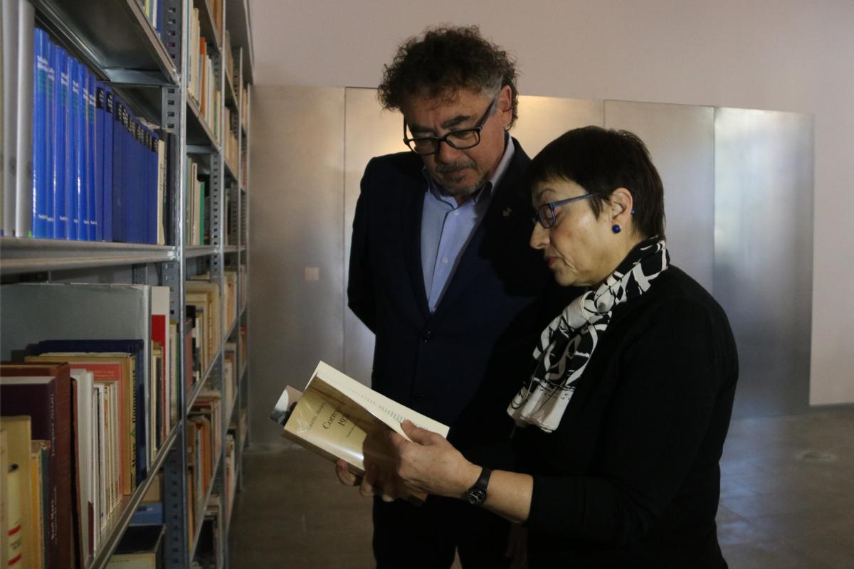 L'alcalde de Portbou, Xavi Barranco, i PIlar Parcerisas consultant un dels llibres de la biblioteca Benjamin.