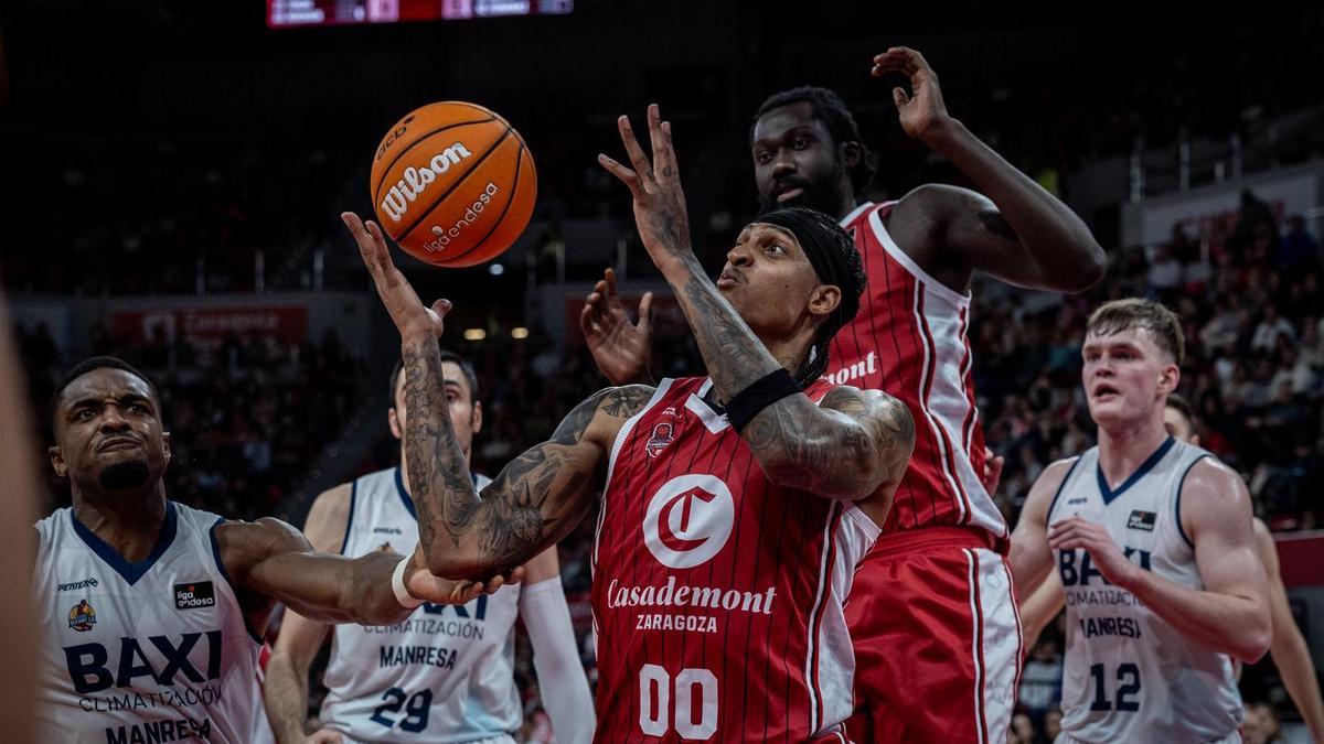 Robinson, con Koumadje detrás, pelea por un balón