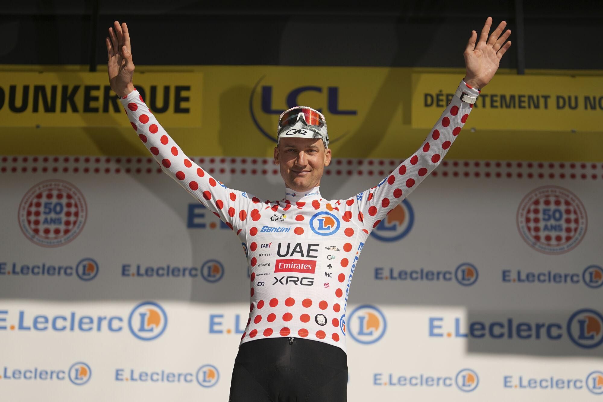 Belgium's Tim Wellens wearing the best climber's dotted jersey celebrates on the podium after the third stage of the Tour de France cycling race over 178.3 kilometers (110.8 miles) with start in Valenciennes and finish in Dunkerque, France, Monday, July 7, 2025. (AP Photo/Thibault Camus)