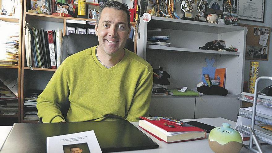 Manuel Mateos posa con el libro que ha escrito sobre la mesa.