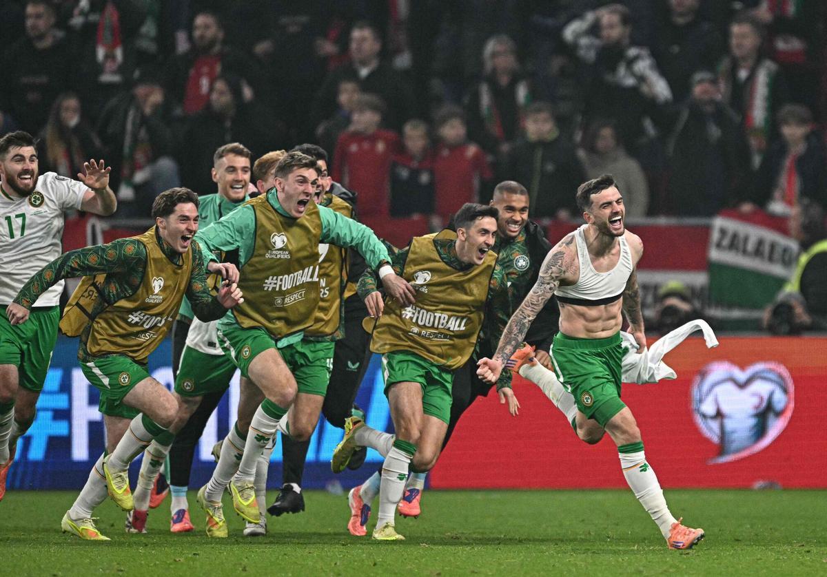 Ireland's forward #07 Troy Parrott (R) celebrates his 2-3 during the FIFA World Cup 2026 Group F European qualification football match betweem Hungary and Republic of Ireland at the Puskas Arena in Budapest, Hungary on Novemeber 16, 2025. (Photo by Attila KISBENEDEK / AFP)