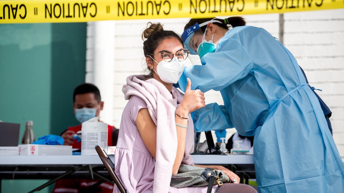 A woman receives the coronavirus vaccine in Los Angeles. A woman receives the coronavirus vaccine in Los Angeles.