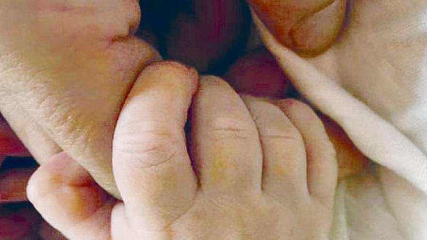 Una mano y los pies del recién nacido, en dos imágenes subidas por los padres a internet.