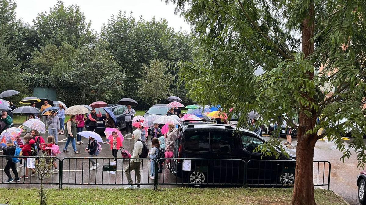 Los niños acceden al Hermanos Arregui entre los coches del Celestino Montoto. | R. L. P.