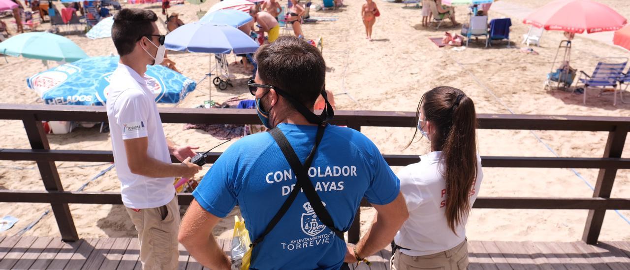 Controladores de las medidas covid de la Generalitat y el Ayuntamiento el verano pasado en la playa del Cura de Torrevieja