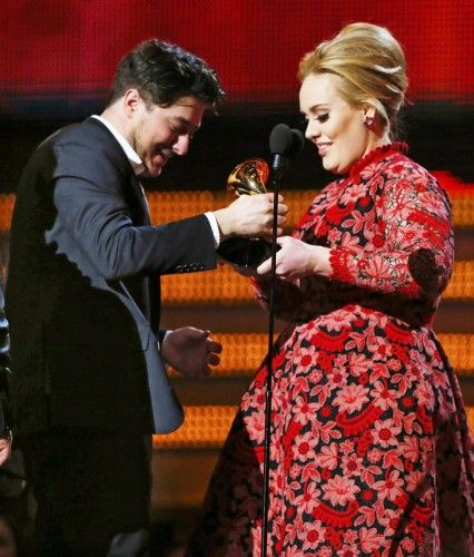 Marcus of Mumford and Sons accepts the Grammy for album of the year for "Babel" from presenter Adele at the 55th annual Grammy Awards in Los Angeles