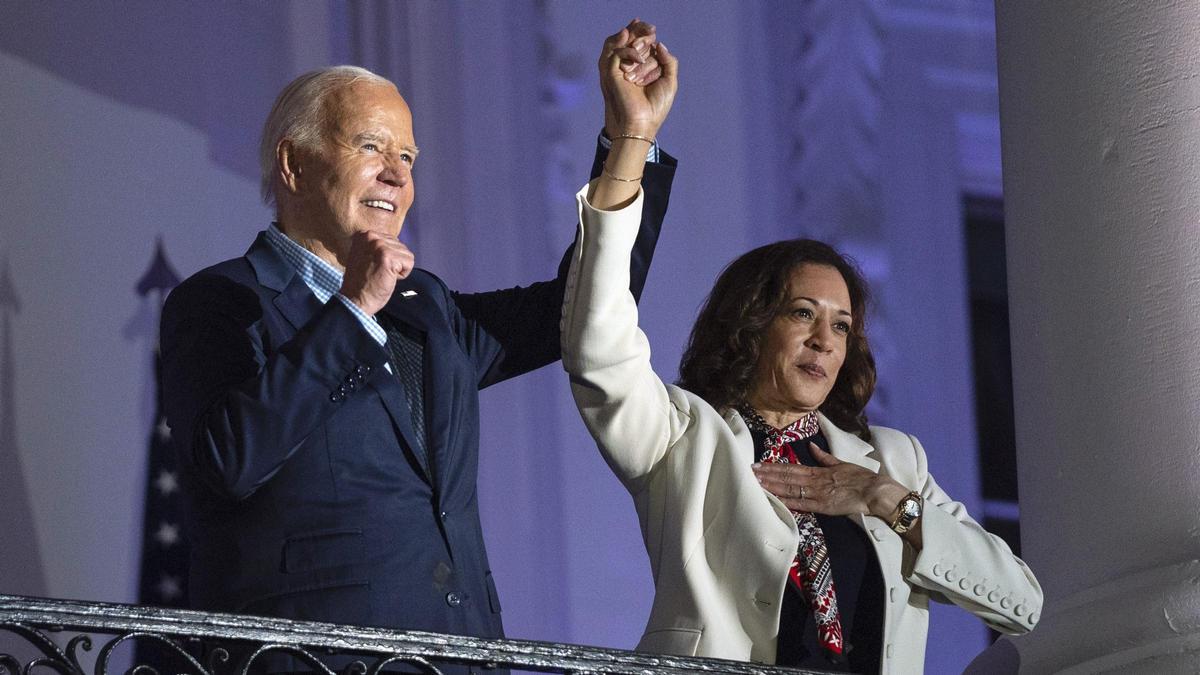 El presidente Joe Biden levanta la mano de la vicepresidenta Kamala Harris durante los fuegos artificiales del Día de la Independencia en el National Mall desde el balcón de la Casa Blanca, el jueves 4 de julio de 2024, en Washington.