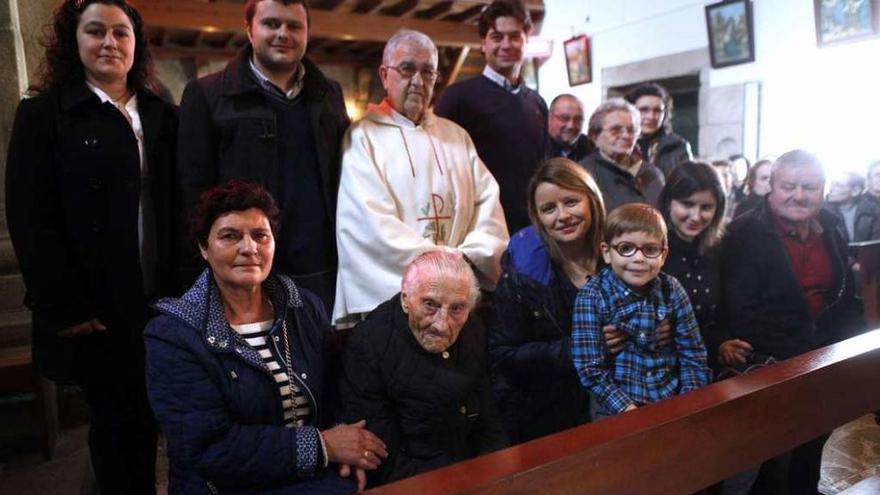 Manuela Souto, ayer, tras la misa, rodeada de su familia y del párroco Xesús Mayo. // Bernabé/