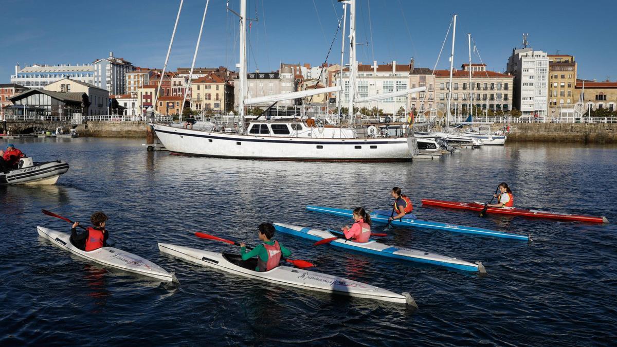 Niños de la sección de piragüismo del Grupo Covadonga, remando en el Muelle.